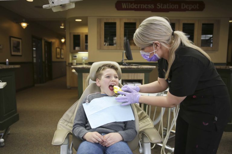 child at the dentist getting fitted for a kids mouth guard