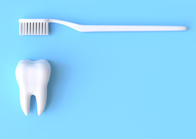 Toothbrush and white tooth on a blue background