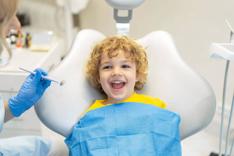 child smiling at the dentist