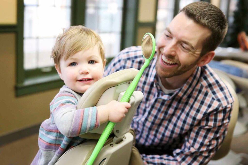 dr marty killeen with a pediatric dental patient at wilderness station pediatric dentistry in lincoln ne